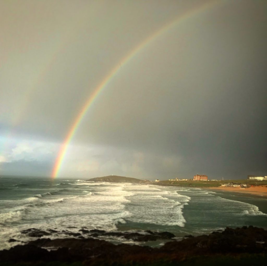 a rainbow over the coast