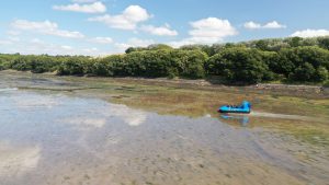 osprey hovercraft sailing down a river
