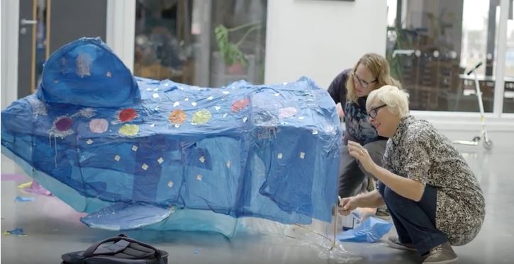 two woman working on an illuminate festival sculpture