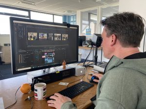 Man working on a computer editing a video