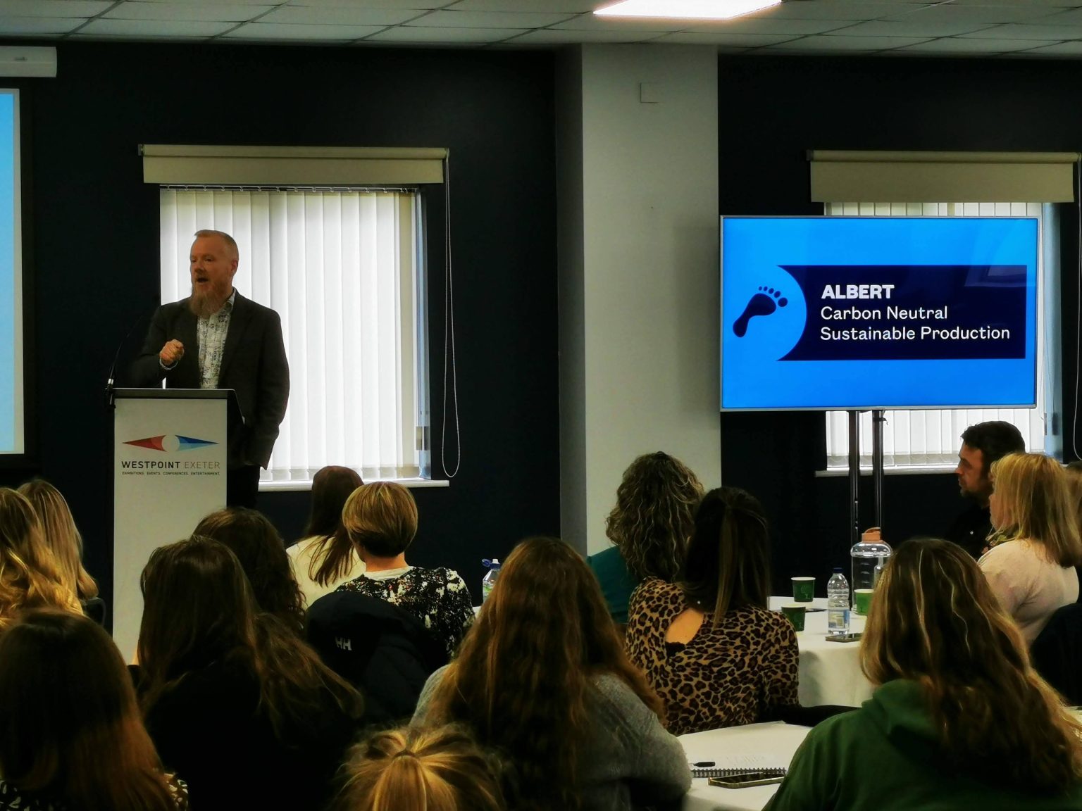 man giving talk at conference showing off his presentation
