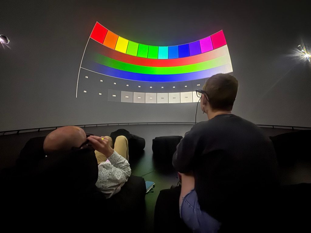 Fulldome production technical set-up inside the dome, with a colour test pattern projected on the screen