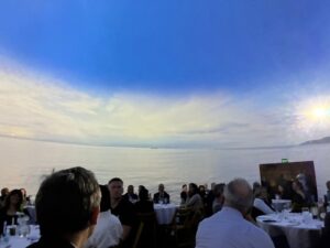 a group of people sat at dinner tables looking around in a 360 immersive media dome