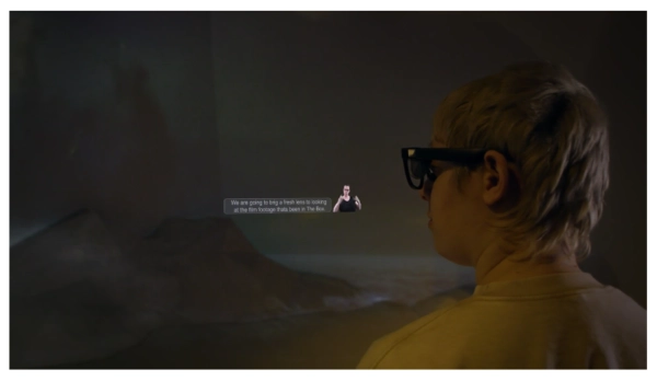 ceri wearing Includiverse glasses with a graphic representation showing BSL and subtitles