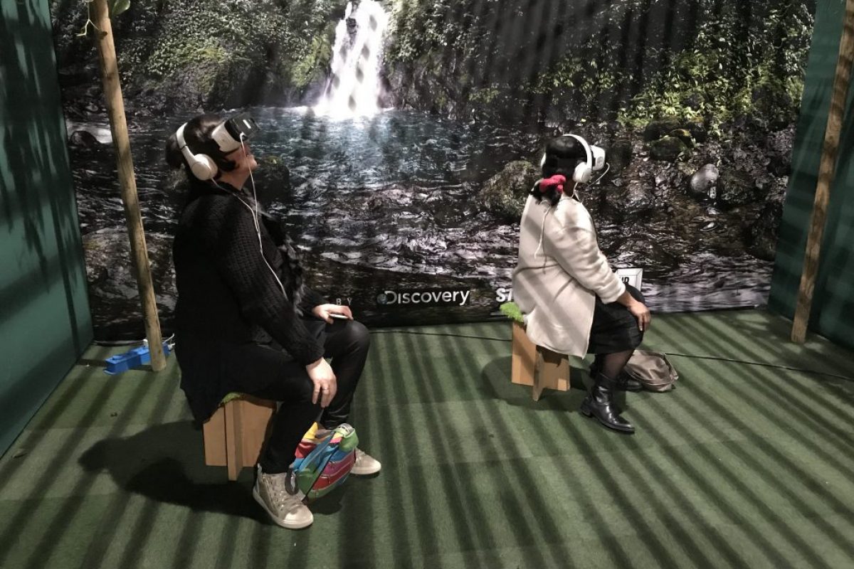 two people in VR headsets sat down interacting
