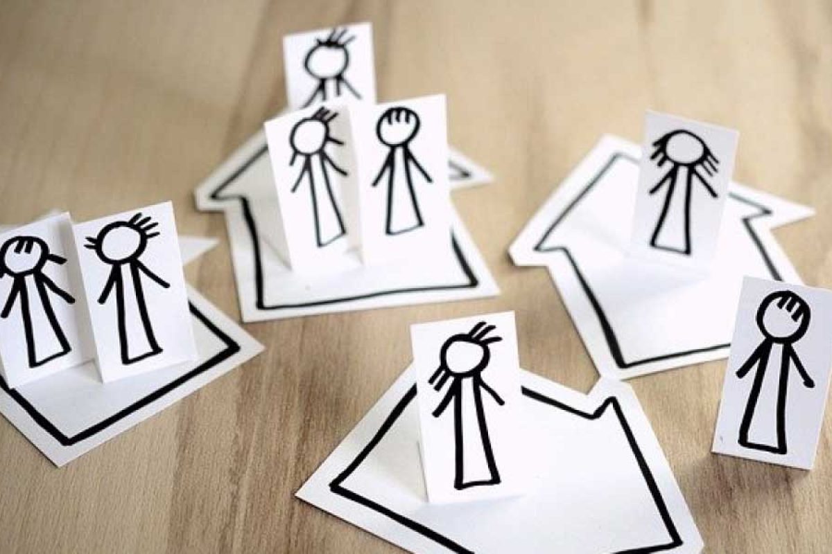 stick figures on paper cutout houses