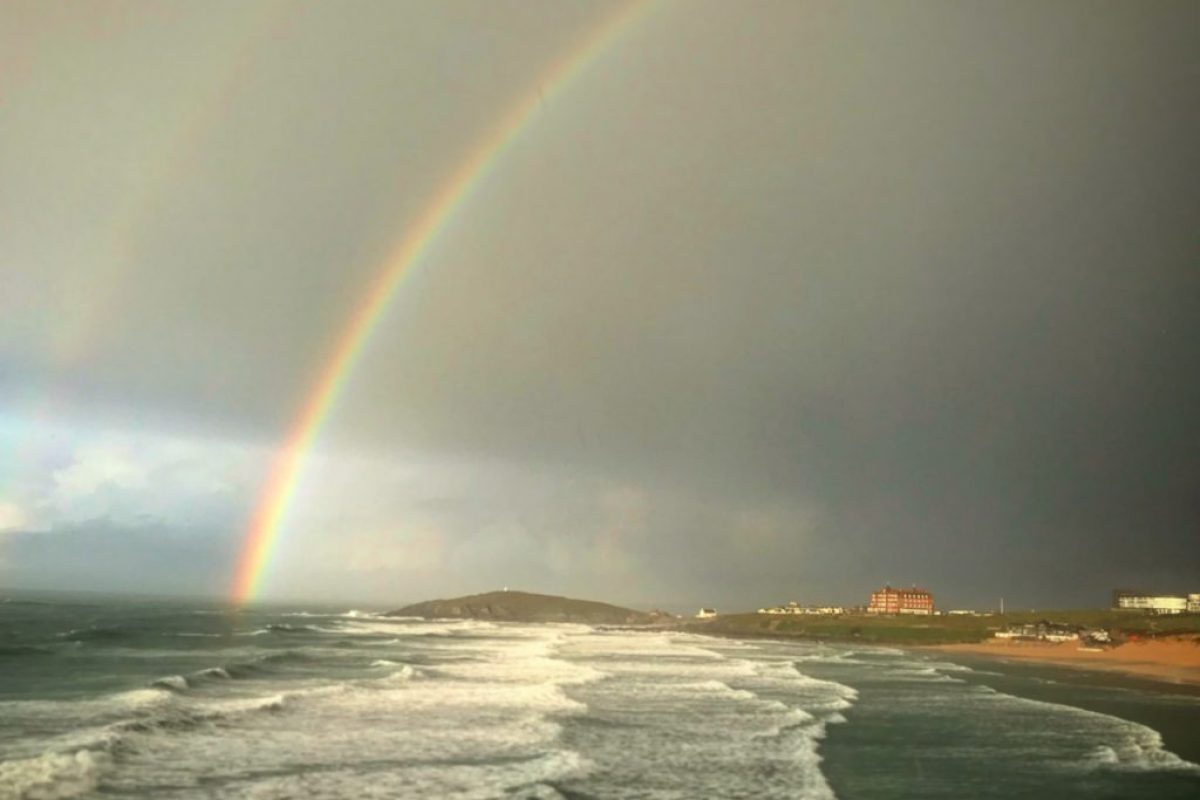 a rainbow over the coast