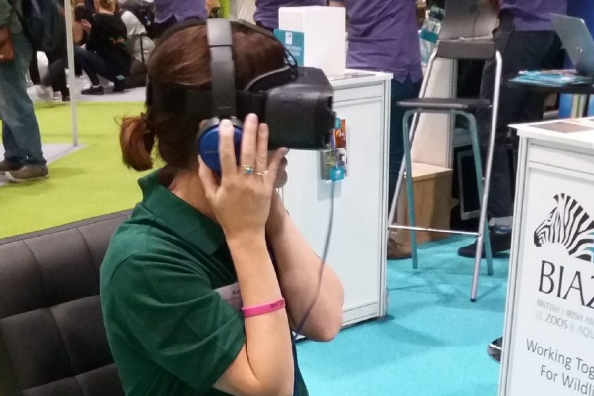 a woman sat with a VR headset and headphones