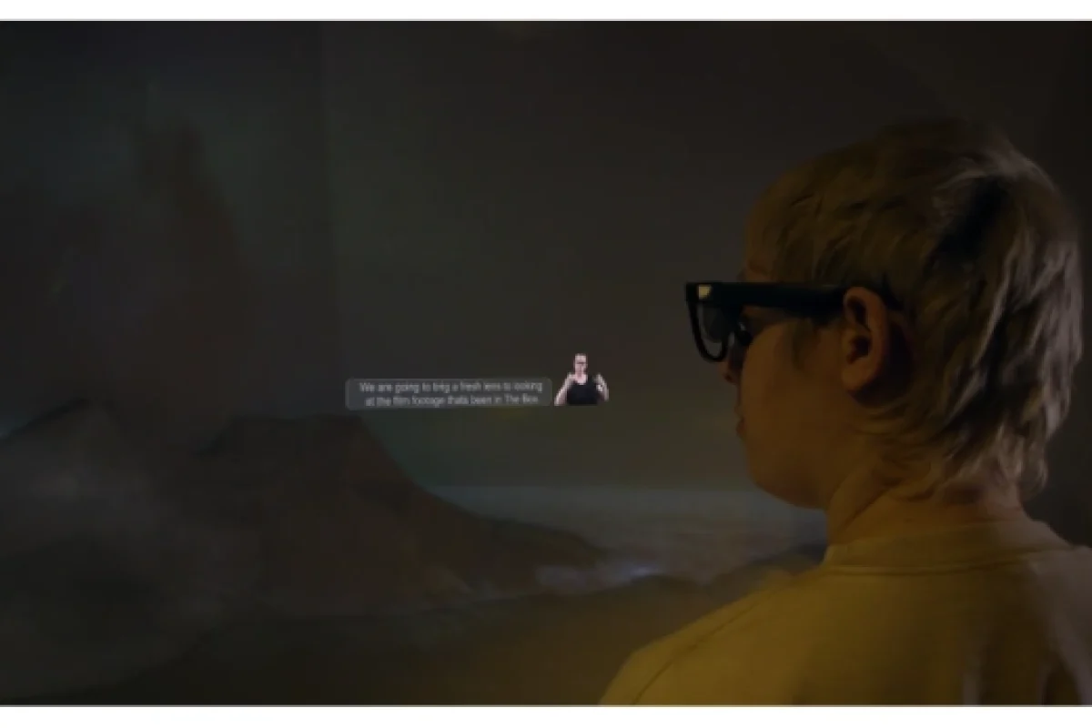 ceri wearing Includiverse glasses with a graphic representation showing BSL and subtitles