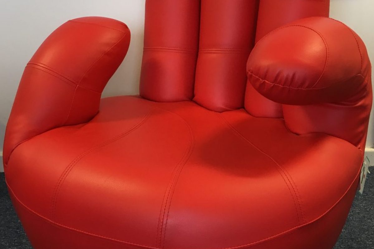 red leather chair in the shape of a hand