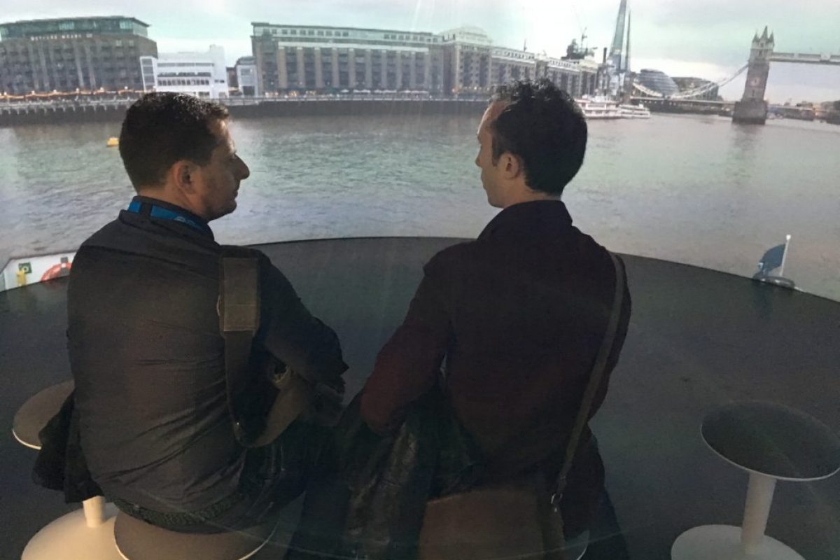 two men sat looking at a projection of the River Thames
